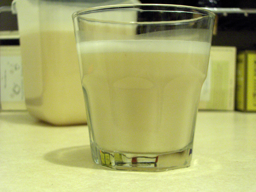 Short glass of frosty, nutty, almond milk 