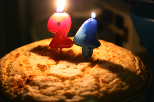 Biscuit-top chicken pot pie casserole with "24" birthday candles lit on top.