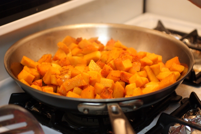 Cubes of squash cooking in a pan